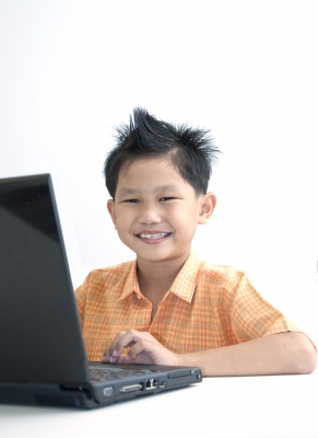 orange shirt kid play laptop